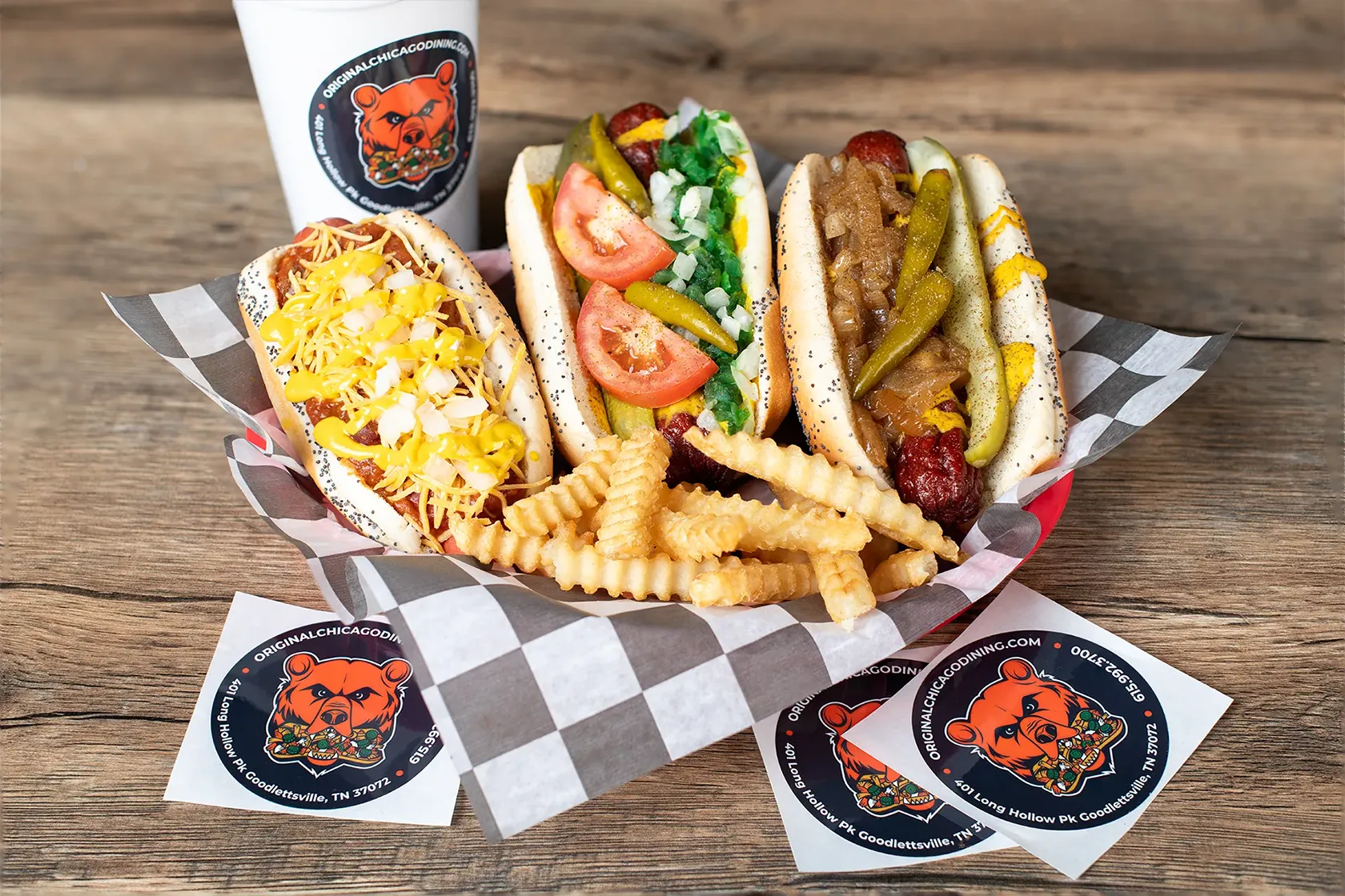 Staleys Chicago Italian Dining 3 Hotdog Meal with a checkered wrapper placed on a wooden table.