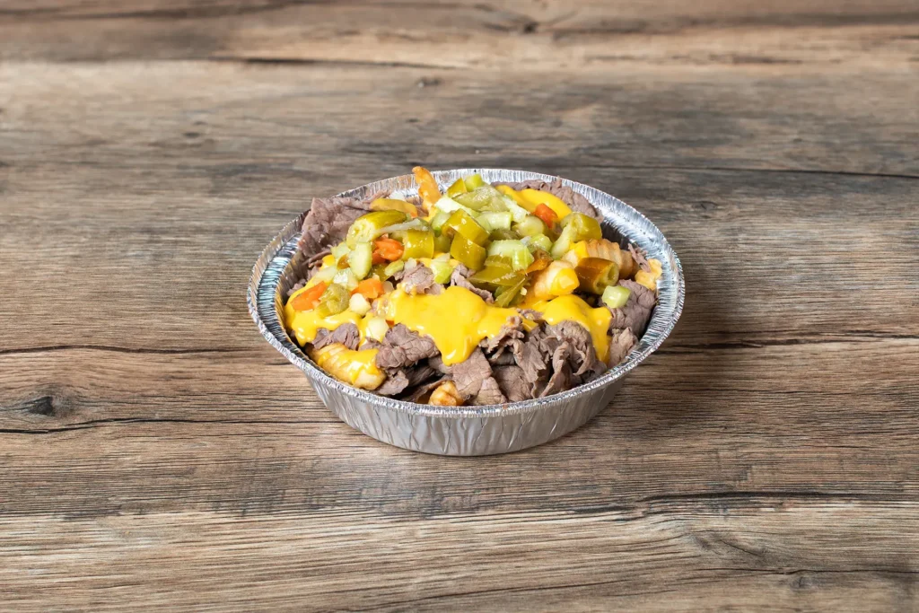 Staleys Italian Beef with Cheese in a bowl placed on a wooden table.