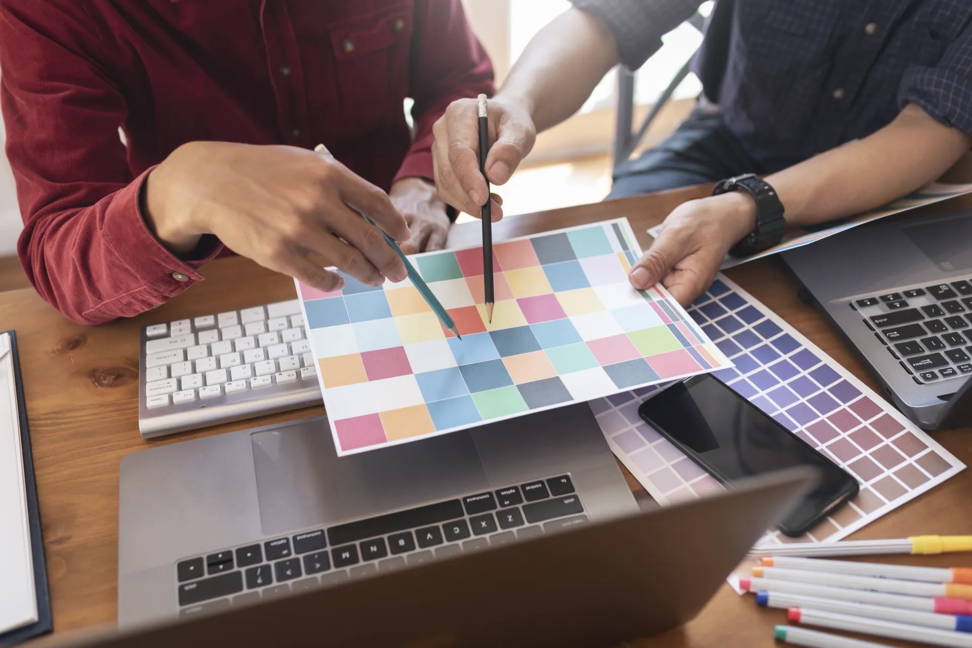 Two web designers picking colors at a desk