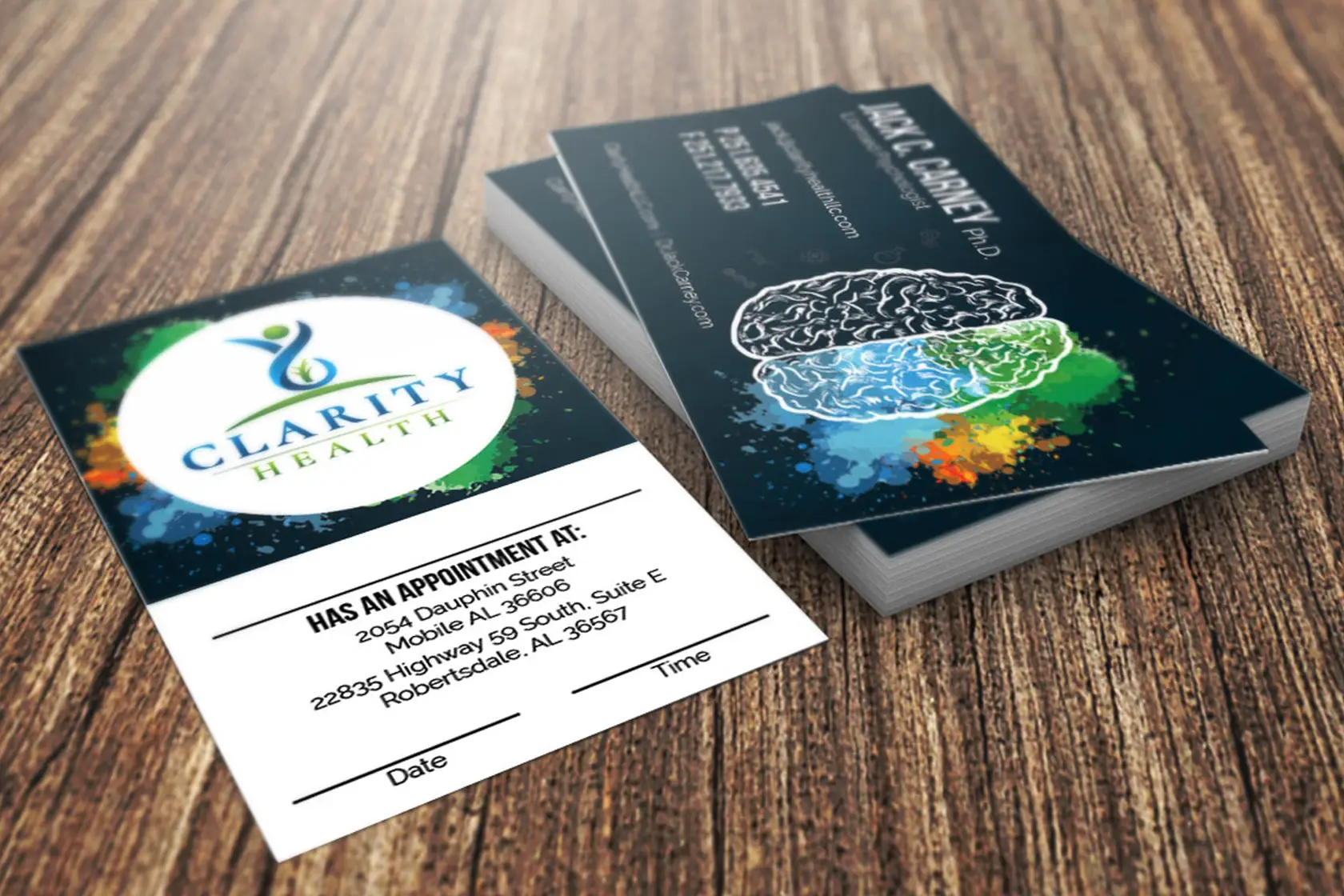 Clarity Health Business Cards on a wooden table