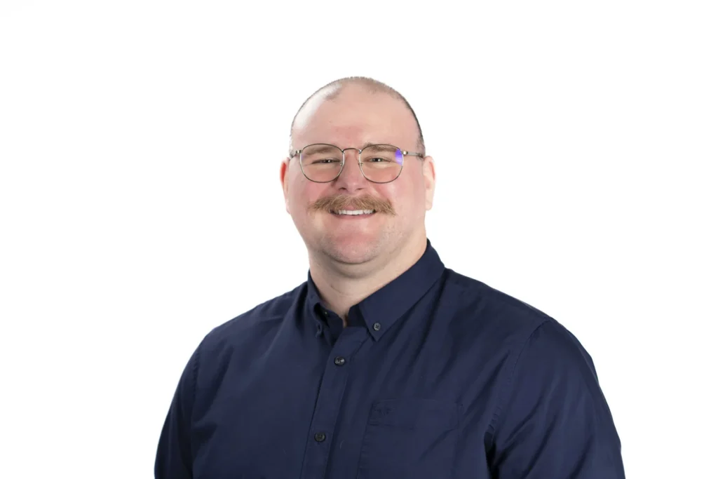 Professional headshot of a man against a white background
