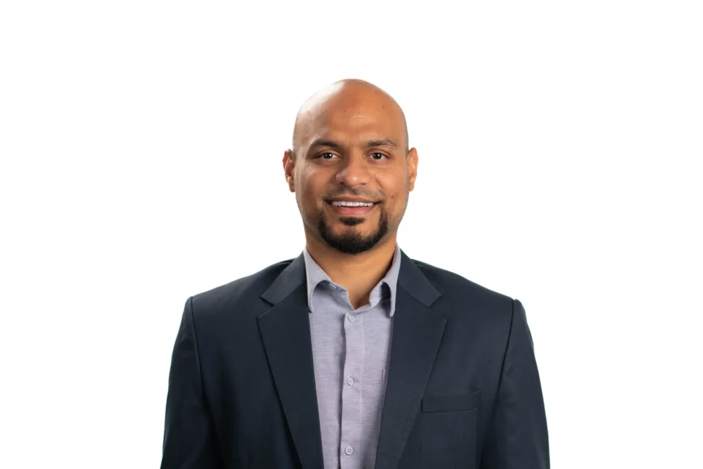 Professional headshot of a man against a white background