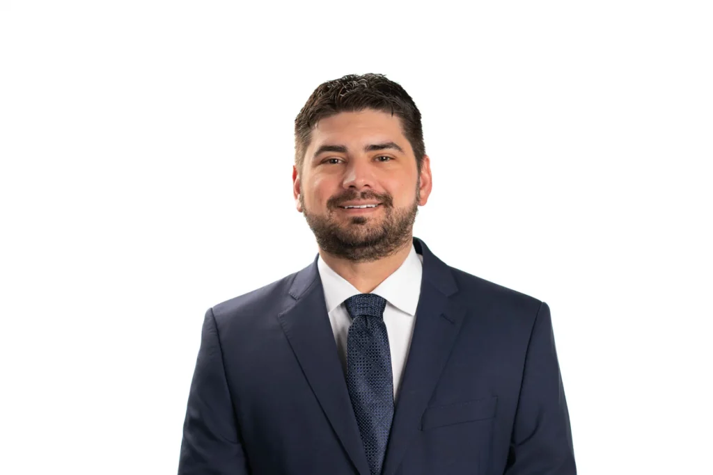 Professional headshot of a man against a white background